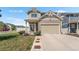 Charming two-story home featuring a two-car garage and a well-maintained lawn with manicured landscaping at 4405 Walden Ct, Denver, CO 80249