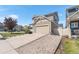 Charming home featuring a two-car garage, driveway, gravel landscaping, and well-maintained lawn at 4405 Walden Ct, Denver, CO 80249