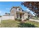 Charming two-story home featuring a covered porch, well-maintained lawn, and manicured landscaping at 4405 Walden Ct, Denver, CO 80249