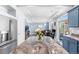 Open concept kitchen featuring blue cabinets, a large island, and seamless flow to the living space at 4405 Walden Ct, Denver, CO 80249