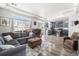Open-concept living room with hardwood floors, large windows, and modern blue kitchen cabinets at 4405 Walden Ct, Denver, CO 80249