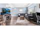 Comfortable living room featuring an entertainment center with fireplace and hardwood floors at 4405 Walden Ct, Denver, CO 80249