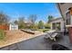 Backyard patio with picnic table, fire pit, gardening boxes and storage sheds at 3002 S Fenton St, Denver, CO 80227