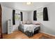 This is a sun-filled bedroom with hardwood floors and a cozy bed at 3002 S Fenton St, Denver, CO 80227