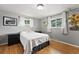 Comfortable bedroom with hardwood floors, grey walls, and ample natural light at 3002 S Fenton St, Denver, CO 80227