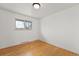 This empty bedroom offers hardwood floors and a window with natural light at 3002 S Fenton St, Denver, CO 80227