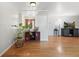 Bright entryway with hardwood floors, a decorative room divider, and an inviting view into the home at 3002 S Fenton St, Denver, CO 80227