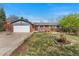 Charming single-story brick home with a well-maintained lawn, inviting curb appeal, and a two car garage at 3002 S Fenton St, Denver, CO 80227