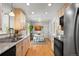 Bright kitchen with light wood cabinets, stainless steel appliances, and a cozy dining area for casual meals at 3002 S Fenton St, Denver, CO 80227