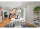 Eat-in kitchen features natural light, adjacent dining area, and sliding glass doors to outdoor patio at 3002 S Fenton St, Denver, CO 80227