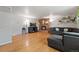 Comfortable living room featuring hardwood floors, a stylish sofa, a brick fireplace, and a mounted television at 3002 S Fenton St, Denver, CO 80227