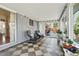 Sunroom with checkered tile and views of backyard is perfect for relaxing and enjoying the outdoors at 3002 S Fenton St, Denver, CO 80227