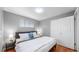 The primary bedroom features a closet and windows that let in lots of light at 1720 Mable Ave, Denver, CO 80229