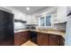 Modern kitchen with updated appliances, granite countertops, and subway tile backsplash at 1720 Mable Ave, Denver, CO 80229