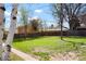 Expansive backyard features mature trees and green grass with plenty of space for outdoor activities at 4320 Lamar St, Wheat Ridge, CO 80033