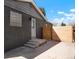 Private backyard featuring new fence, painted gray brick, and concrete patio with steps to the back door at 4320 Lamar St, Wheat Ridge, CO 80033
