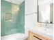 Stylishly renovated bathroom with green tiled shower, new vanity, and modern fixtures at 4320 Lamar St, Wheat Ridge, CO 80033