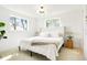 Bright bedroom featuring neutral colors, large windows, and hardwood floors at 4320 Lamar St, Wheat Ridge, CO 80033
