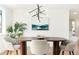 Bright dining room features a modern chandelier, contemporary art, and seating for four, perfect for gatherings at 4320 Lamar St, Wheat Ridge, CO 80033