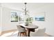 A bright and modern dining area featuring a minimalist chandelier and natural light at 4320 Lamar St, Wheat Ridge, CO 80033