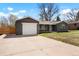 Picture displays a ranch style house with a white two car garage and concrete driveway at 4320 Lamar St, Wheat Ridge, CO 80033