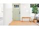 Home entryway boasting a light blue door, and natural wood bench, accented by a lush plant at 4320 Lamar St, Wheat Ridge, CO 80033