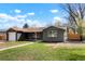 Charming home boasts gray painted brick, a well-maintained lawn and a driveway leading to the garage at 4320 Lamar St, Wheat Ridge, CO 80033