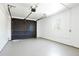 Clean, organized garage featuring a dark door, bright lighting, and ample space for vehicles and storage at 4320 Lamar St, Wheat Ridge, CO 80033