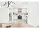 Bright, open-concept kitchen features white cabinets, stainless steel appliances, and modern finishes at 4320 Lamar St, Wheat Ridge, CO 80033