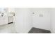 Laundry area features modern appliances, updated flooring, and easy access to hookups and the kitchen at 4320 Lamar St, Wheat Ridge, CO 80033