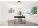 Bright home office featuring two windows, a stylish desk, and a cozy chair on a colorful rug at 4320 Lamar St, Wheat Ridge, CO 80033