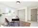Bright home office featuring a large window, a stylish desk, and a cozy chair on a colorful rug at 4320 Lamar St, Wheat Ridge, CO 80033