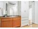 Bathroom with a wooden vanity, large mirror, and built-in storage cabinets at 1196 N Grant St # 405, Denver, CO 80203
