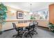 Conference room with an oval table, rolling chairs, and a window with natural light at 1196 N Grant St # 405, Denver, CO 80203