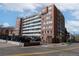 Brick apartment building with many windows and on-site parking at 1196 N Grant St # 405, Denver, CO 80203