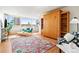 Inviting living room with a colorful rug, a large window, and a unique murphy bed design at 1196 N Grant St # 405, Denver, CO 80203
