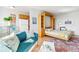 Bright, flexible living space featuring sofa, open murphy bed and small kitchenette at 1196 N Grant St # 405, Denver, CO 80203