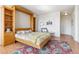Comfortable bedroom with built-in shelving and a bed, showcasing cozy decor and natural light at 1196 N Grant St # 405, Denver, CO 80203