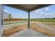 Backyard of a home with a patio area overlooking an open grassy area at 2177 Flower Blossom Ave, Brighton, CO 80601