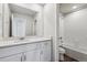 Bright bathroom showcases white cabinets, a large mirror and a shower-tub combo at 2177 Flower Blossom Ave, Brighton, CO 80601