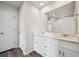 A bright bathroom featuring a double sink vanity, quartz countertops, and a glass enclosed shower at 2177 Flower Blossom Ave, Brighton, CO 80601