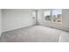 Well-lit bedroom with plush carpeting and bright views from three windows at 2177 Flower Blossom Ave, Brighton, CO 80601
