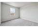 Bedroom with neutral carpet and large window for ample natural light at 2177 Flower Blossom Ave, Brighton, CO 80601
