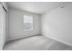 Bedroom featuring a window with blinds and soft carpet at 2177 Flower Blossom Ave, Brighton, CO 80601
