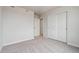 Bright bedroom with carpet, white walls and white doors including large sliding closet doors at 2177 Flower Blossom Ave, Brighton, CO 80601