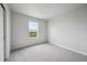 Bright bedroom with gray carpet, light walls, and a window view at 2177 Flower Blossom Ave, Brighton, CO 80601