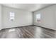 This bedroom has hard wood floors and two windows that provide plenty of natural light at 2177 Flower Blossom Ave, Brighton, CO 80601
