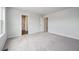 Open bedroom with carpet and two entry doors to adjacent rooms at 2177 Flower Blossom Ave, Brighton, CO 80601