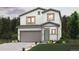 Charming two-story home featuring a gray two-car garage and an inviting, landscaped front yard at 2177 Flower Blossom Ave, Brighton, CO 80601