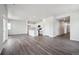 Open concept kitchen features white cabinets, a kitchen island, and modern appliances at 2177 Flower Blossom Ave, Brighton, CO 80601
